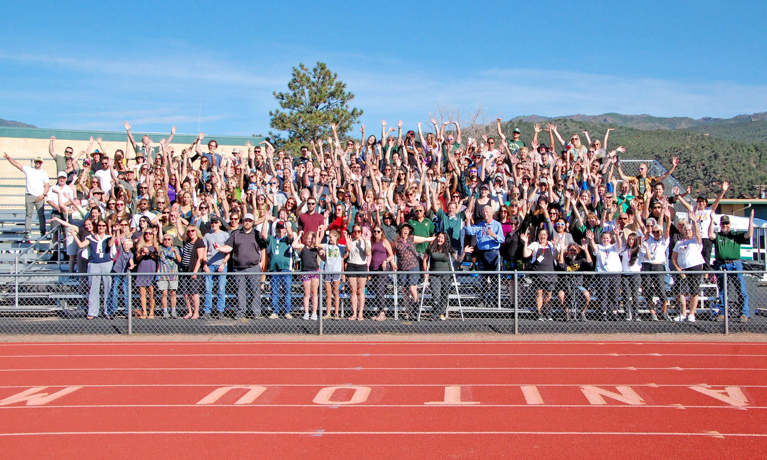 Photo by Rhonda Van Pelt. District 14 teachers, staff and administrators wave from the bleachers at Manitou Springs High School on Monday, Aug. 15.