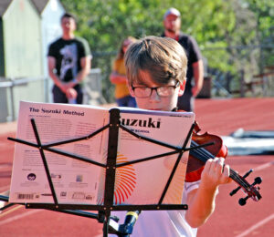 Photo by Rhonda Van Pelt. Quinn Scott, who will be an eighth-grader at Manitou Springs Middle School, concentrates as he plays his violin for District 14 personnel on Monday, Aug. 15.
