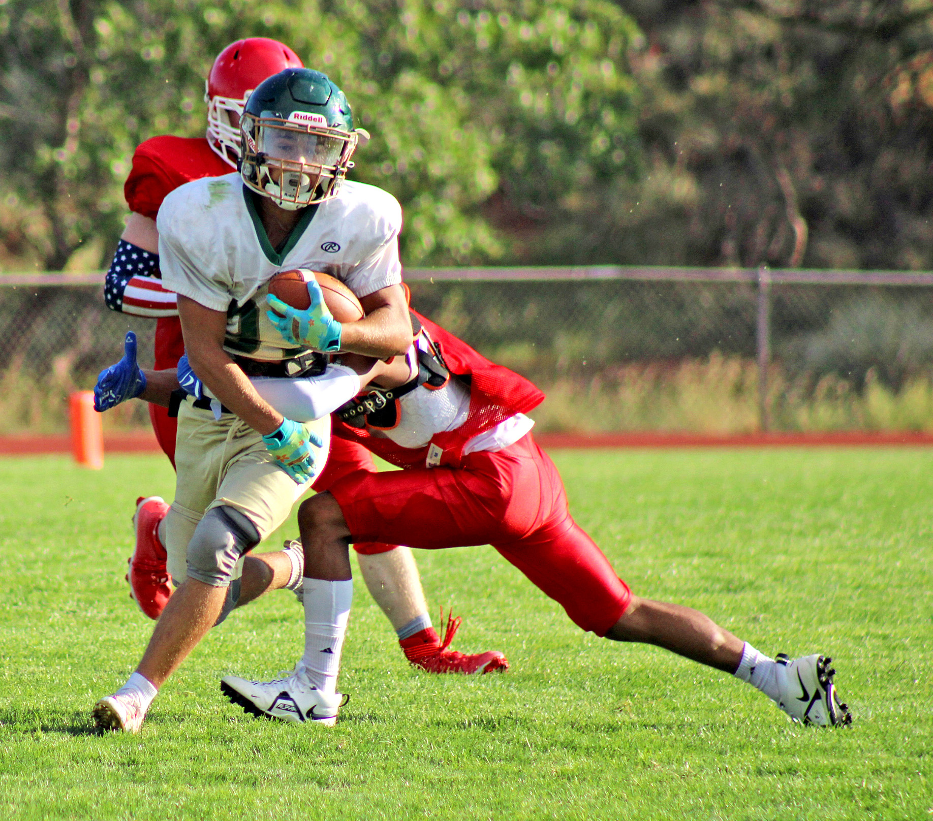 Photo by Daniel Mohrmann. Tyler Maloney gets wrapped up during Manitou football’s scrimmage against Buena Vista on Aug. 12.