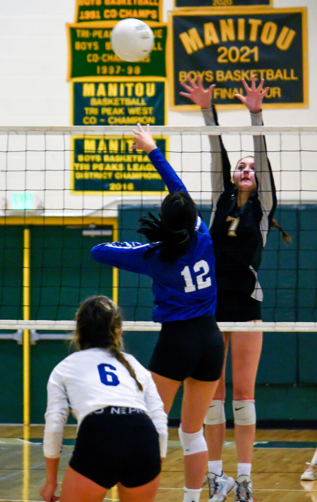 Photo by Bryan Oller. Hannah Ruger is set to block the ball during Manitou’s match against Pueblo Central.