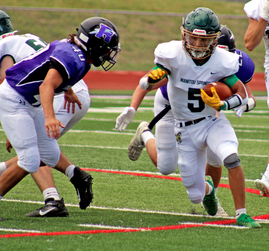 Photo by Daniel Mohrmann. Tyler Maloney (5) carries the ball during Manitou’s 21-20 loss to Rye last August. Maloney ran for 78 yards and a touchdown in that game.