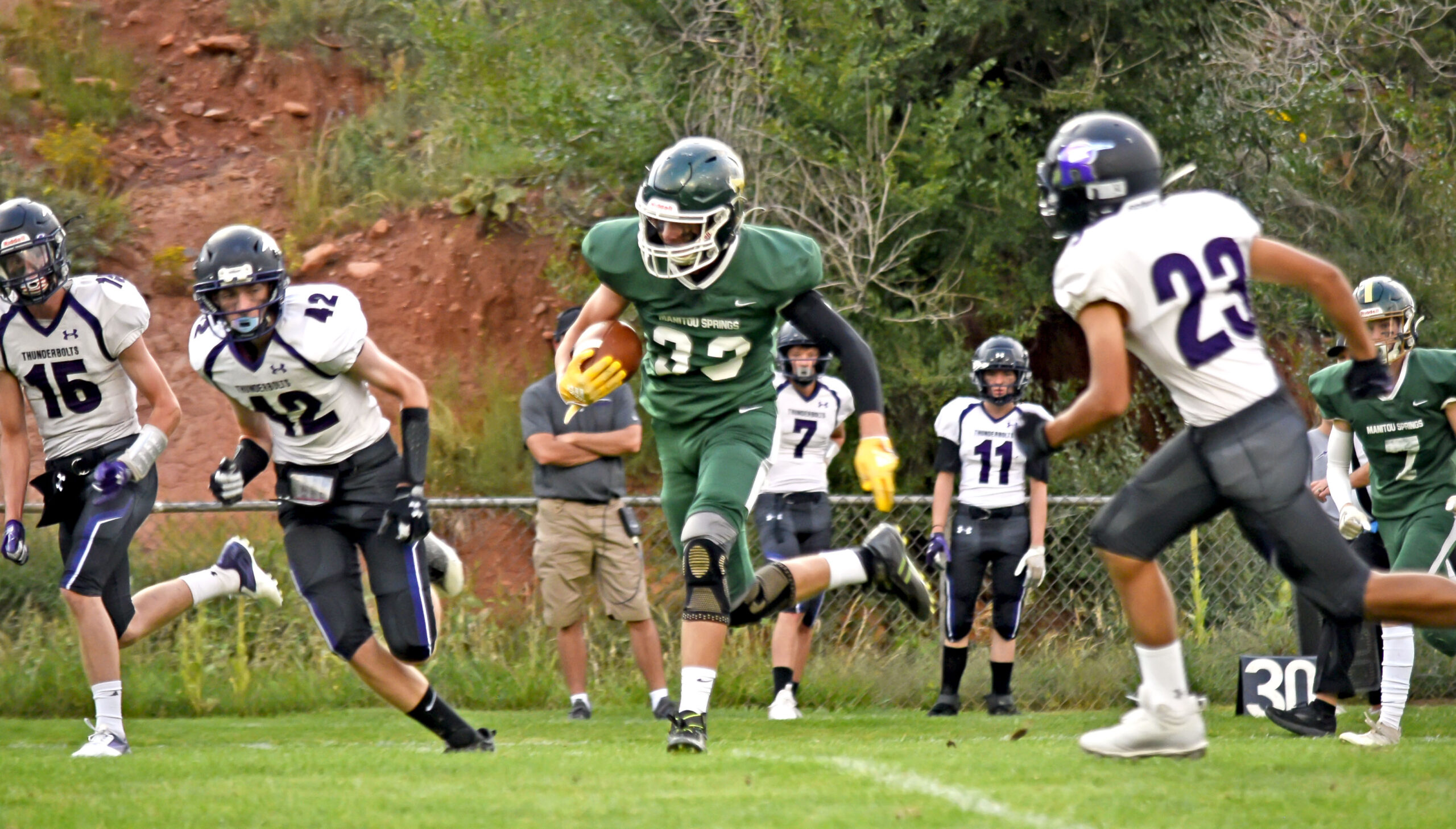 Photo by Bryan Oller. Logan Moore carries the ball during the first quarter against Rye.