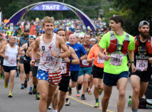 Photo by Bryan Oller. Runners head out from downtown Manitou Springs during a previous race.