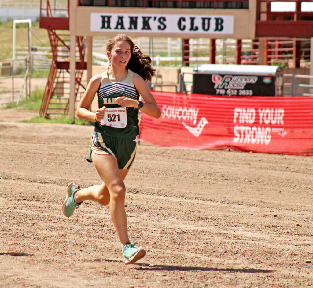 Photo by Daniel Mohrmann. Manitou freshman Ellen Lowe nears the finish during the Cheyenne Mountain Stampede cross-country meet on Sept. 2.