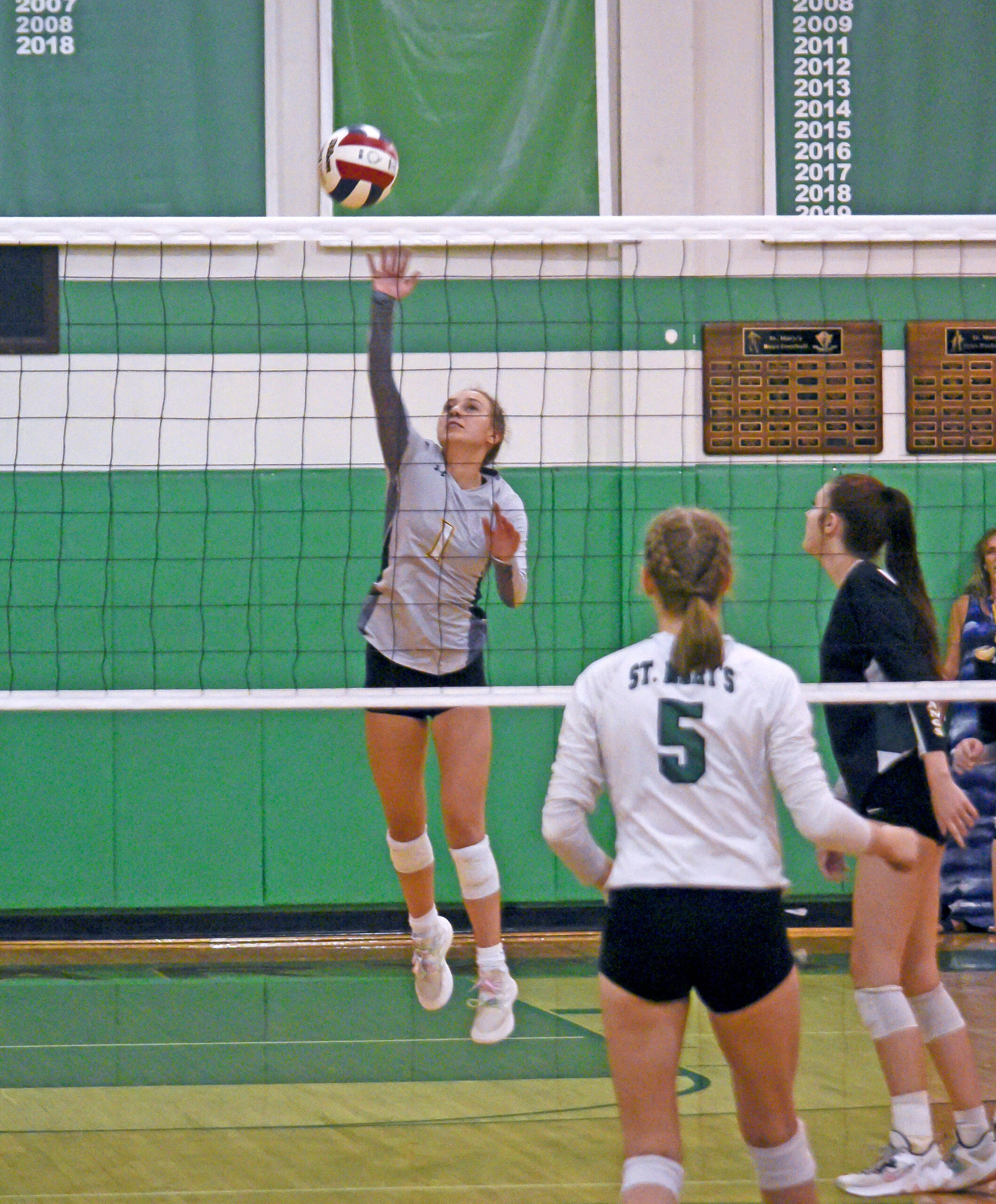 Photo by Bryan Oller. Norah Jorstad defends the net during the Mustangs’ Sept. 13 match against St. Mary’s.