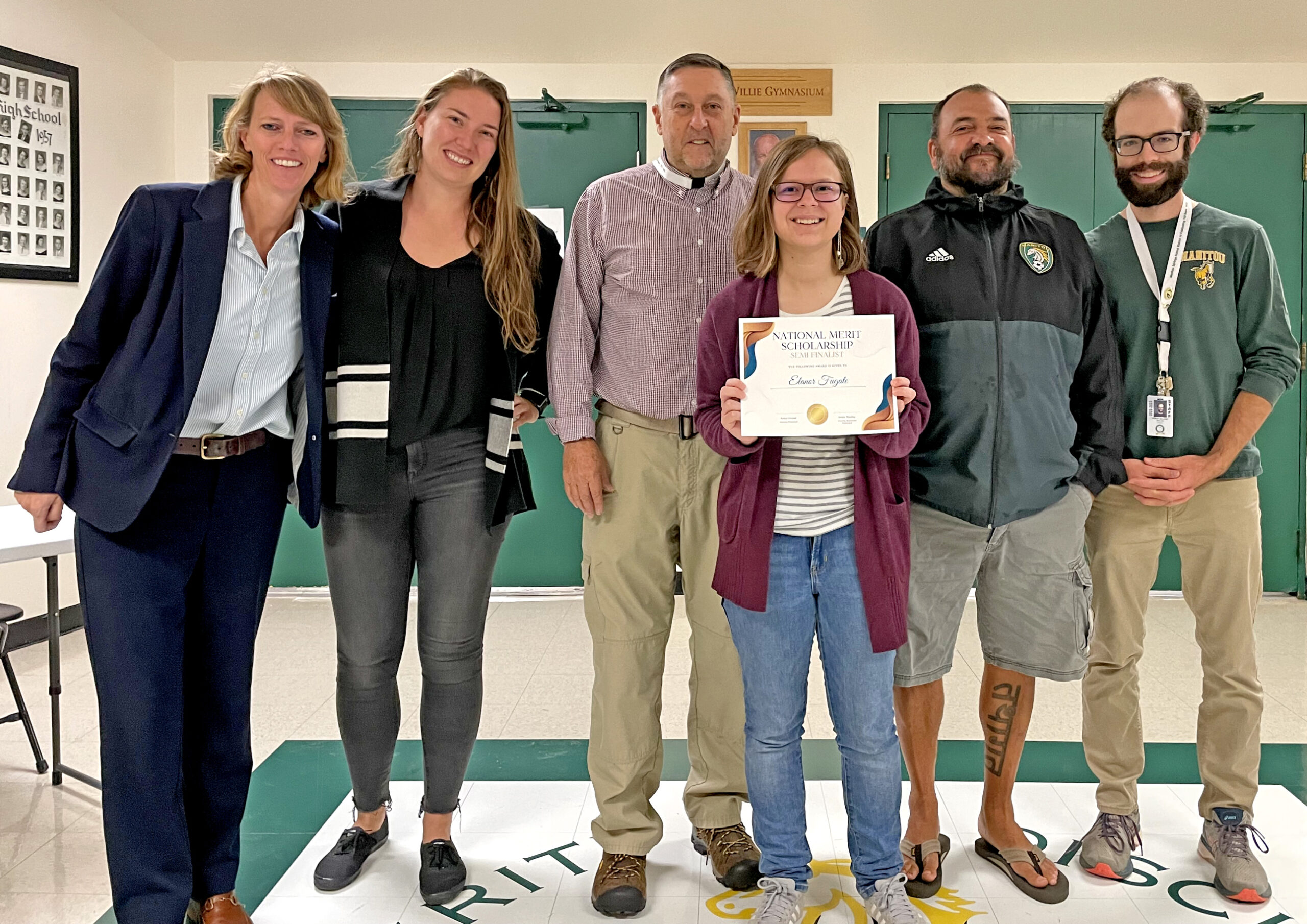 Elanor Fugate receives the 2023 Merit Scholarship Semifinalist Award with, from left, Elizabeth Domangue, Anna Conrad, Mike Talbott, Benjamin Mack and Pierce Gillard by her side.