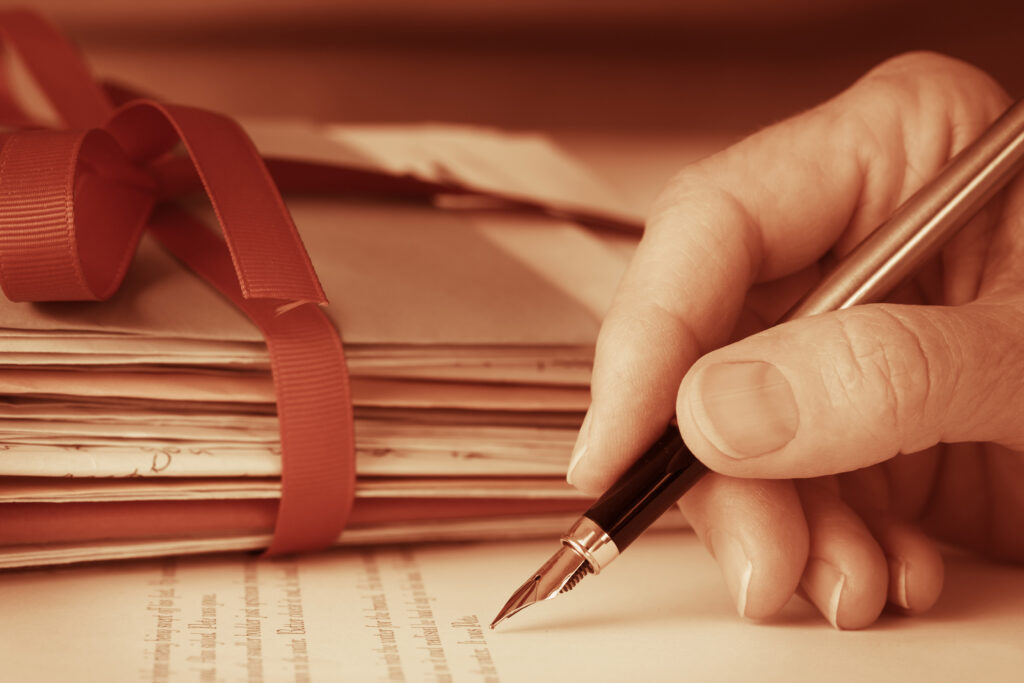 image of hand holding a pen and writing