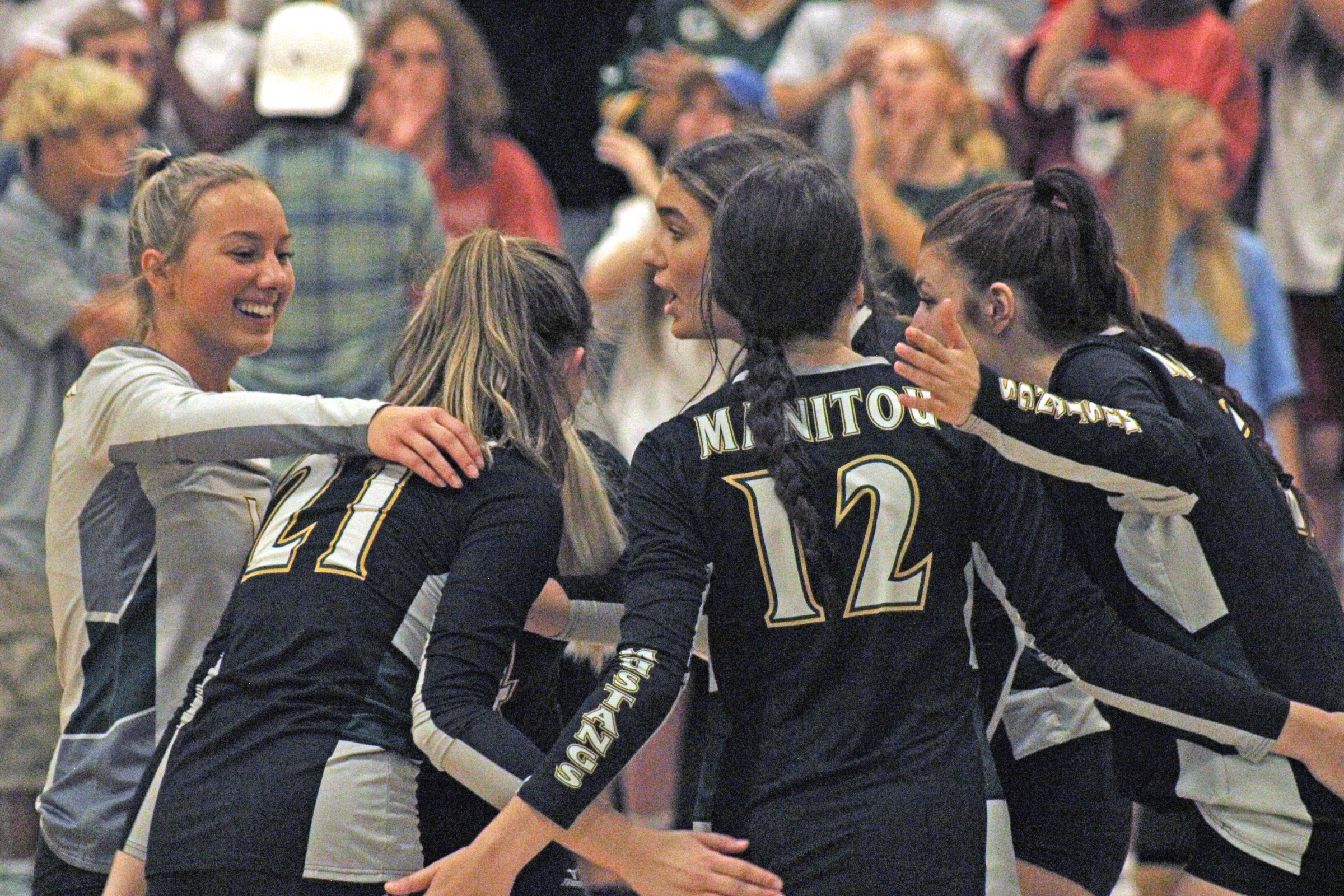 Photo by Daniel Mohrmann. The Manitou Springs volleyball team celebrates winning a crucial point during the win over TCA on Sept. 26.