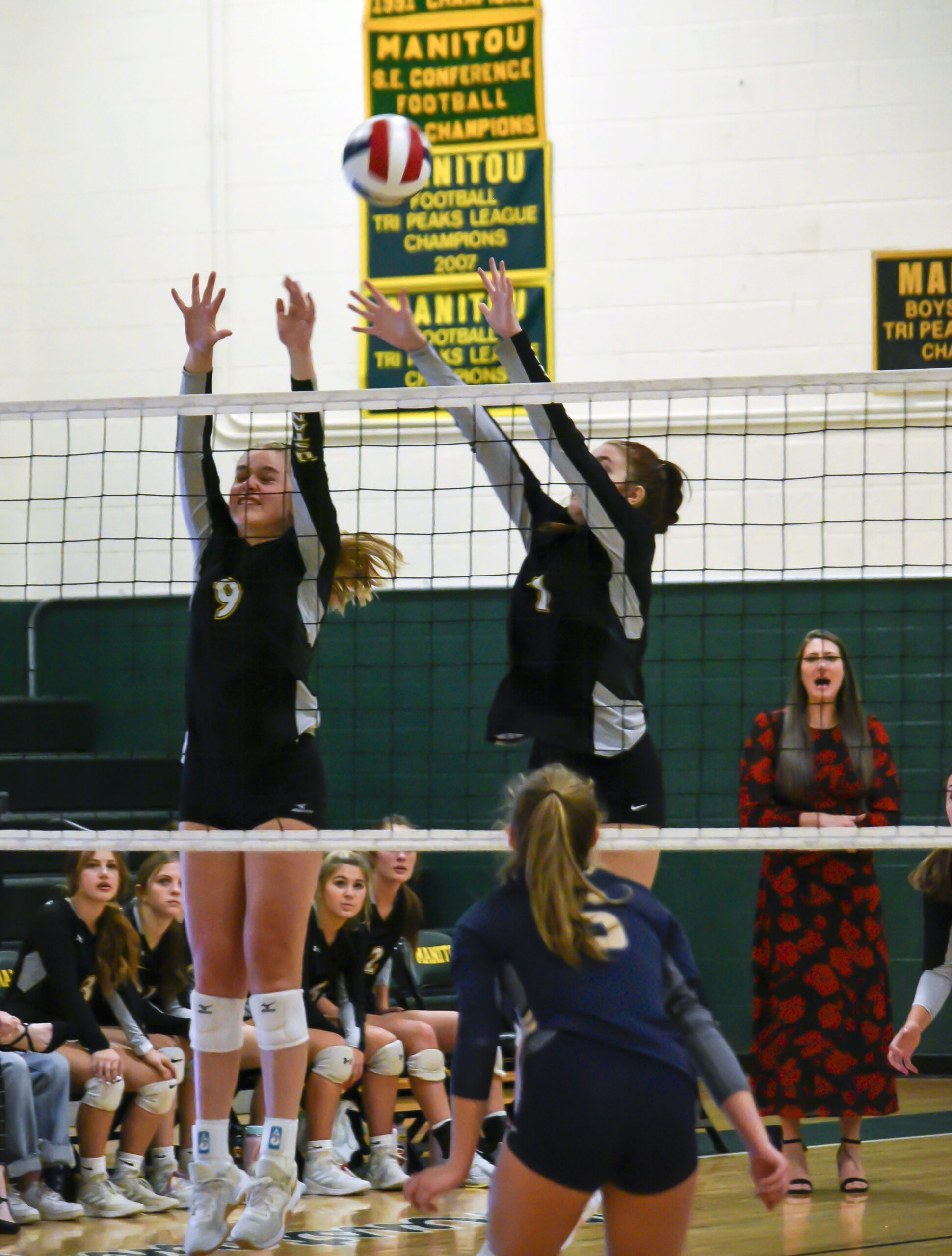 Photo by Bryan Oller. Sierra Dunlap, left, and Hannah Ruger defend the Mustangs’ net during the Vanguard match.