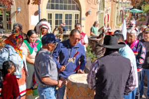 Photo by Rhonda Van Pelt.  The Red Spirit Drum Group performs near the Spa Building.