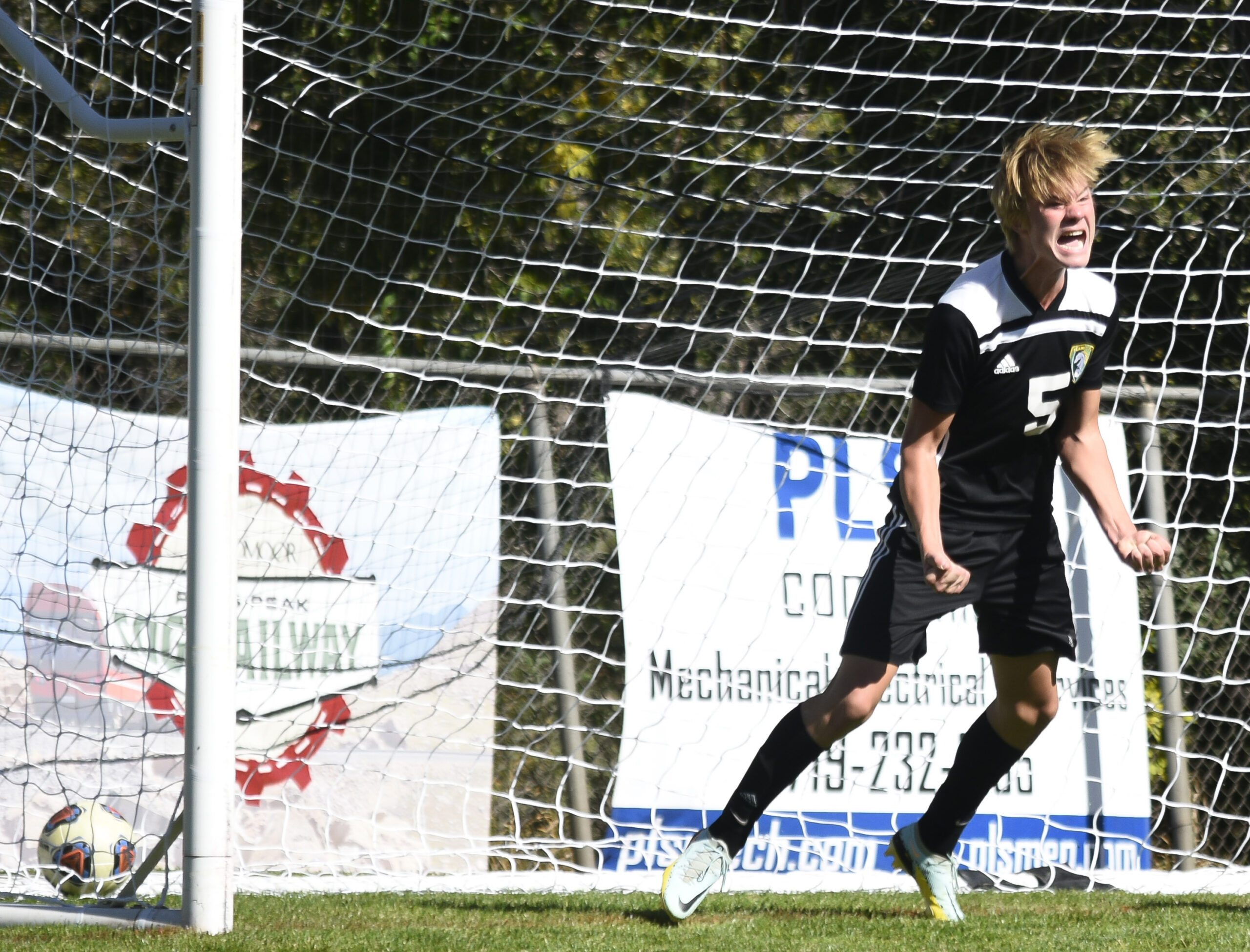 Photo by Bryan Oller. Gavin Smith yells encouragement to his teammates during the Mustangs’ match against Pagosa Springs.