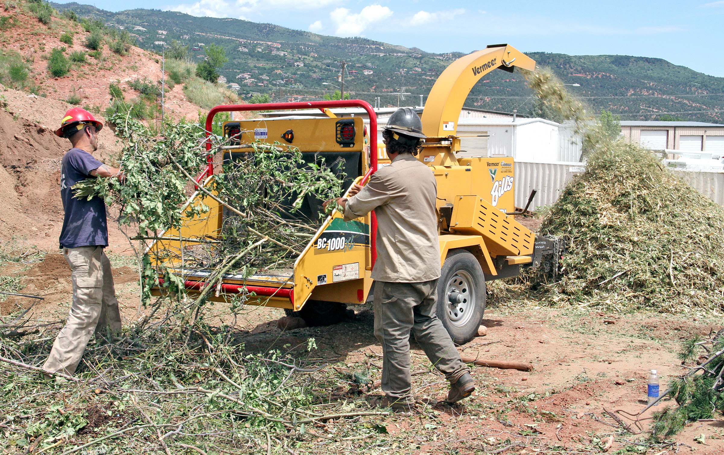 A woodchipper spews out mulch during a previous Chipper Day. Bulletin file photo