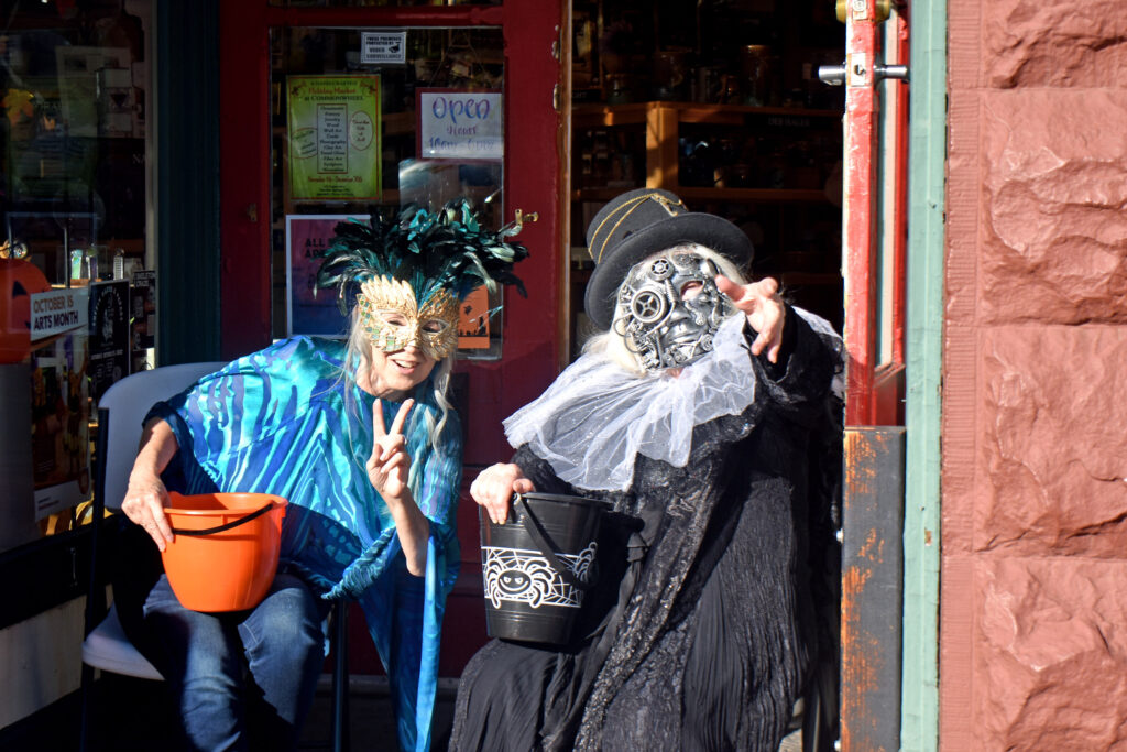 Two Commonwheel artists wait for the next trick-or-treaters.