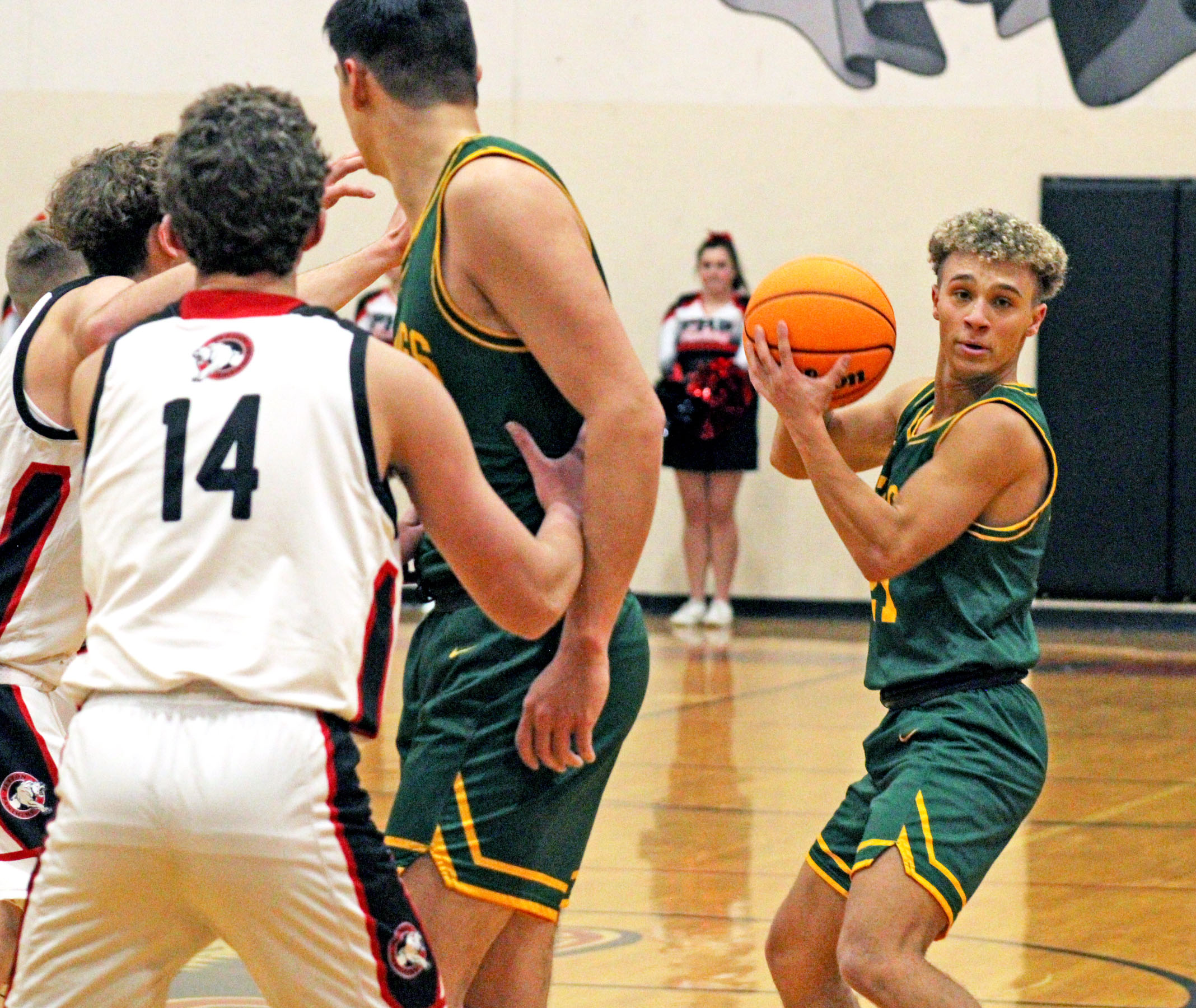 Photo by Daniel Mohrmann. Manitou guard Tyler Maloney looks for an open teammate during the Mustangs’ win over Peyton on Nov. 30.