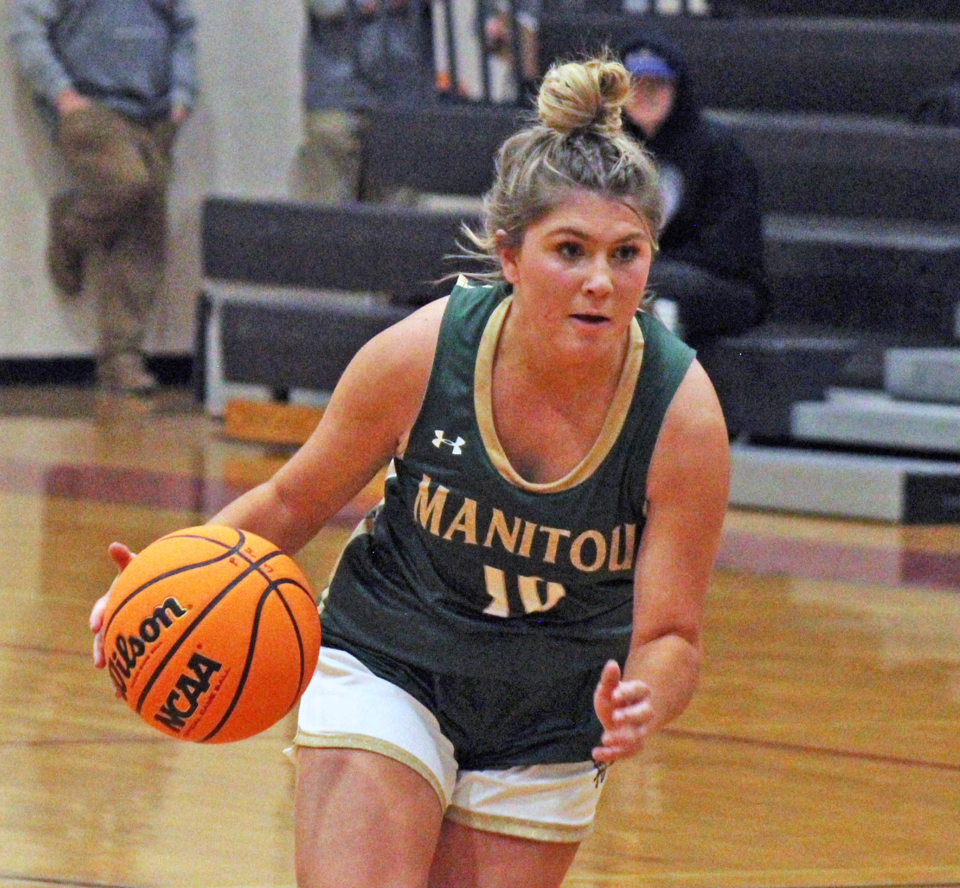 Photo by Daniel Mohrmann. Manitou guard Tyler Maloney looks for an open teammate during the Mustangs’ win over Peyton on Nov. 30.