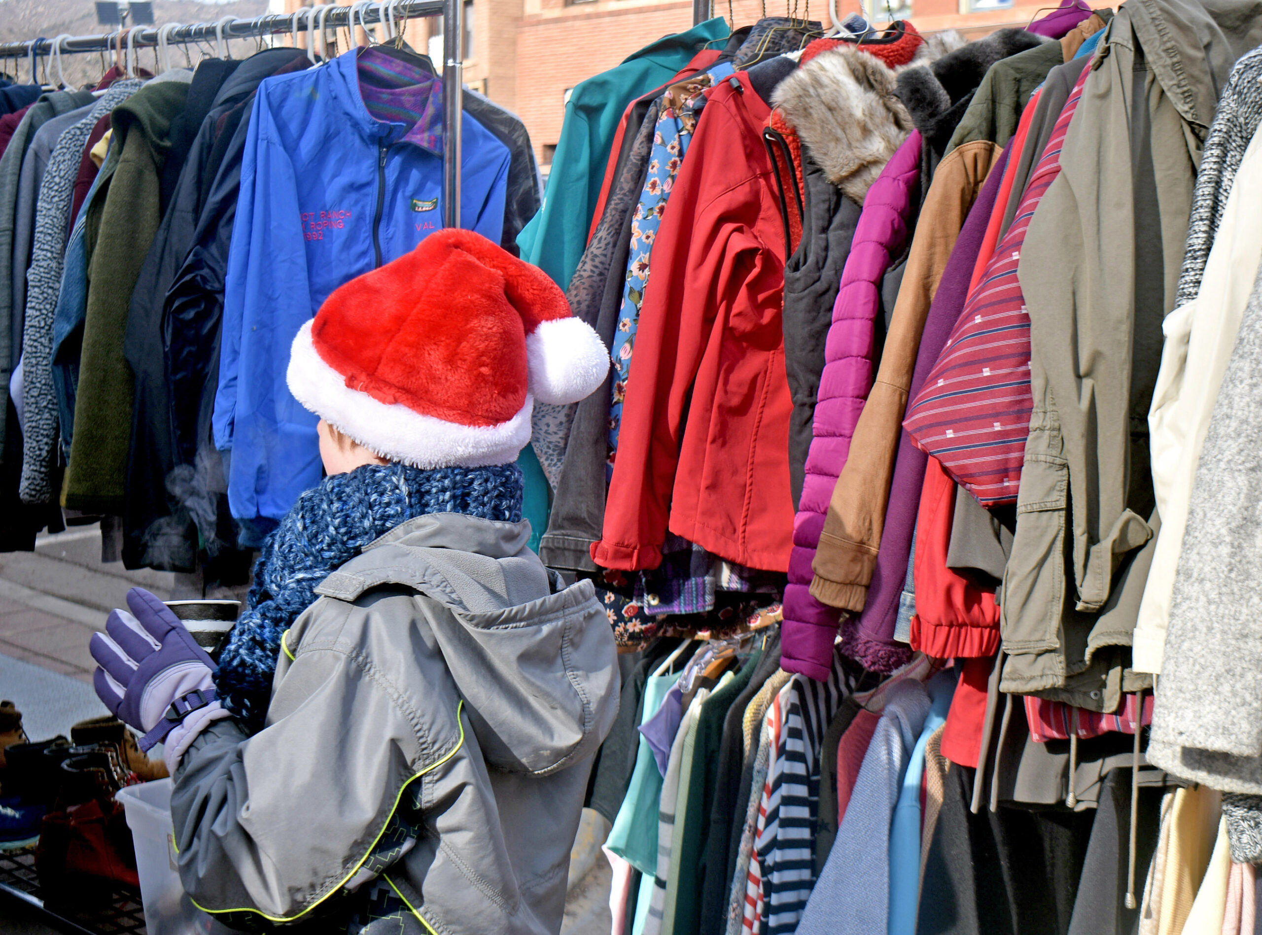 Photo by Rhonda Van Pelt. An elf helps out at Manitou Springs Real Estate’s warm clothing giveaway on Saturday, Dec. 3. The community was very generous this year; most of the unclaimed items were donated to Westside CARES.