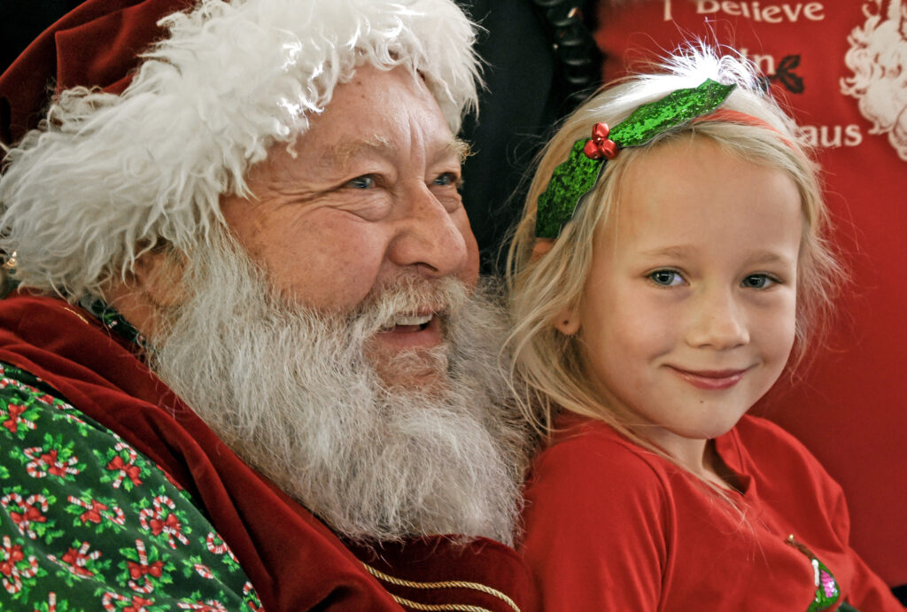 Photo by Bryan Oller. Santa made his annual appearance at the Manitou Springs Kiwanis Club’s annual event, which took place at the Community Congregational Church on Dec. 10. Remi Willie, 6, sits on Santa’s lap.