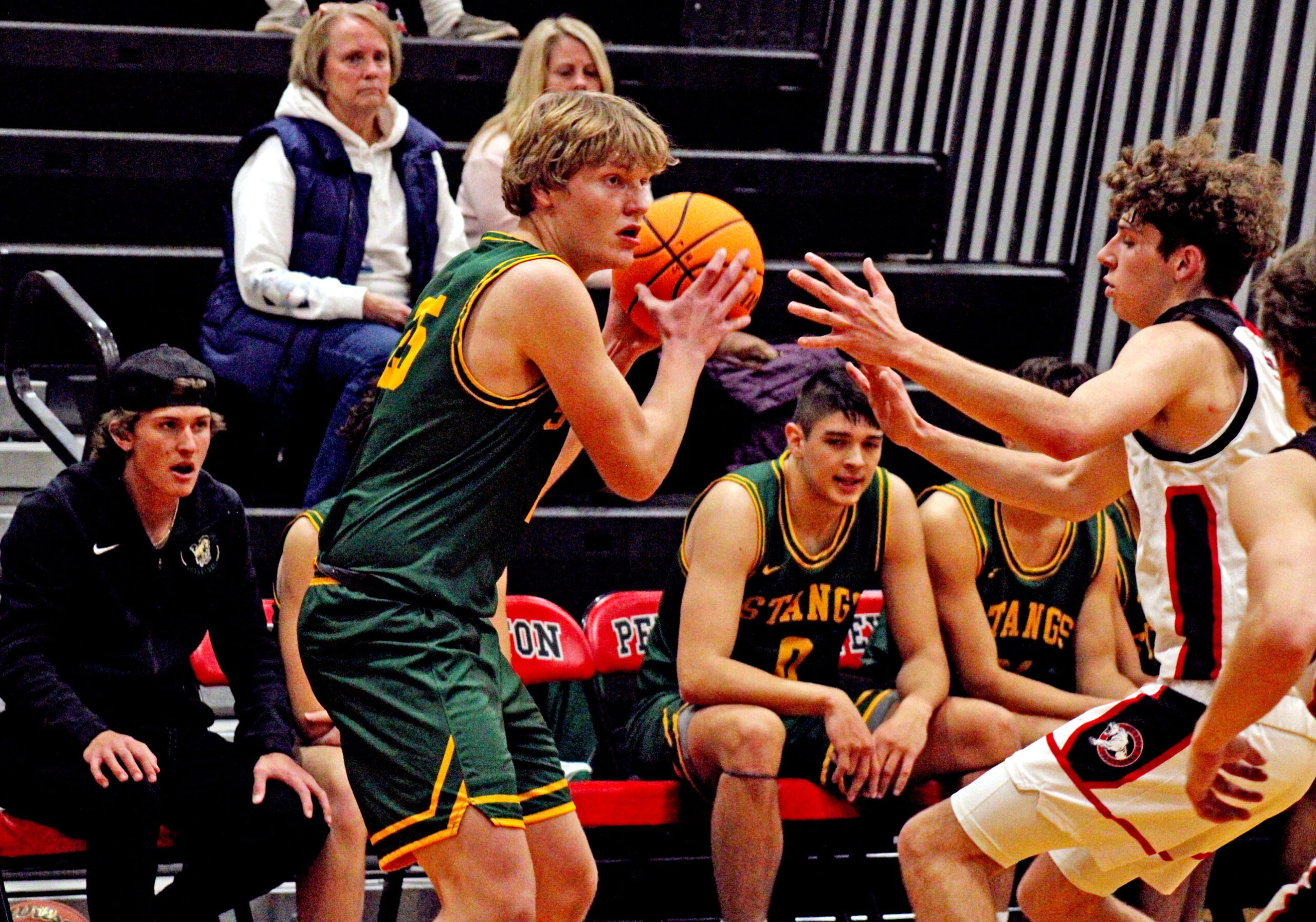 Photo by Daniel Mohrmann. Manitou Springs forward Nate Gentzel waits for an open shooter during the Mustangs’ win over Peyton on Nov. 30.