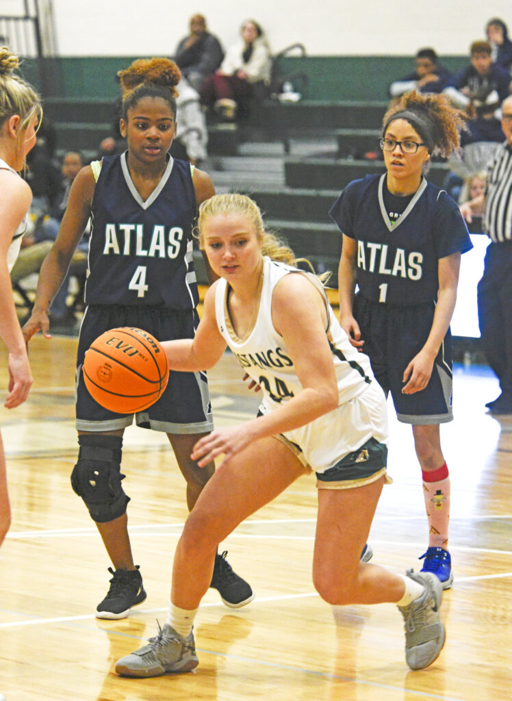 Photo by Bryan Oller. Sami Benge-Kulzer dribbles the ball away from Atlas Prep players.