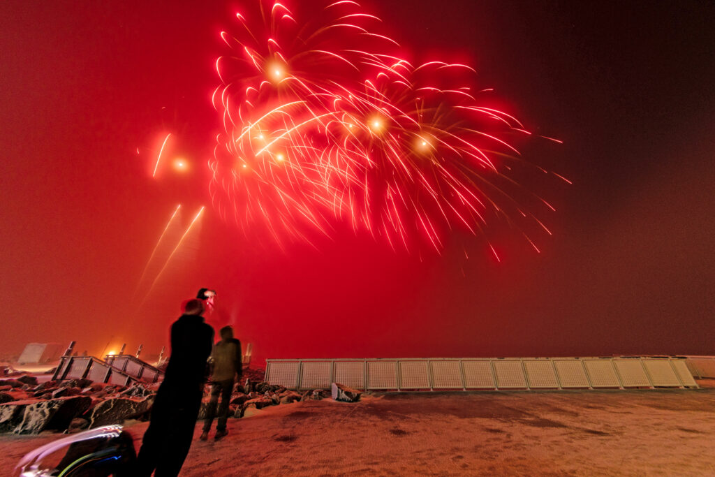Photo by Mike Pach. A few members watch the fireworks on the summit.